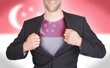 Image showing Businessman opening suit to reveal shirt with flag