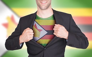 Image showing Businessman opening suit to reveal shirt with flag