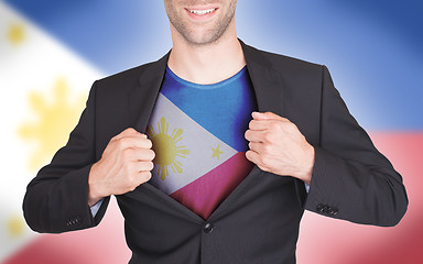 Image showing Businessman opening suit to reveal shirt with flag