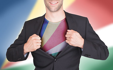 Image showing Businessman opening suit to reveal shirt with flag