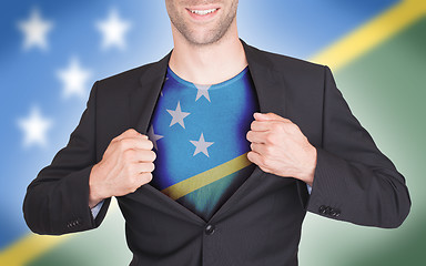 Image showing Businessman opening suit to reveal shirt with flag