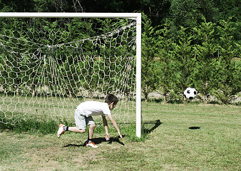 Image showing Child playing football in a stadium