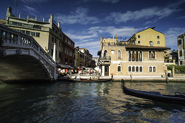 Image showing Ancient buildings and boats in the channel in Venice