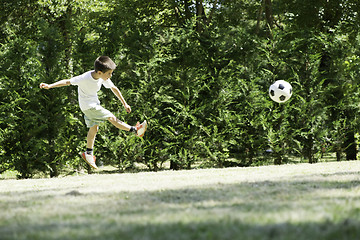 Image showing Child playing football in a stadium