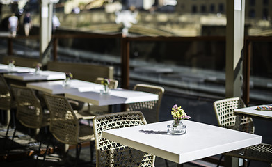 Image showing Authentic italian coffee tabl?. Flowers on the table