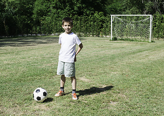 Image showing Child playing football in a stadium