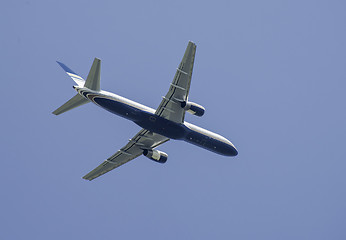 Image showing Flying plane on blue sky background