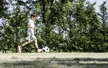 Image showing Child playing football in a stadium