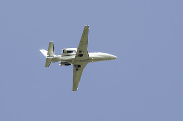 Image showing Flying plane on blue sky background
