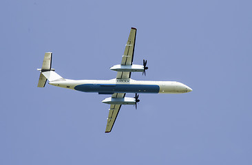 Image showing Flying plane on blue sky background