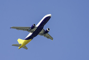 Image showing Flying plane on blue sky background