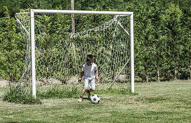 Image showing Child playing football in a stadium