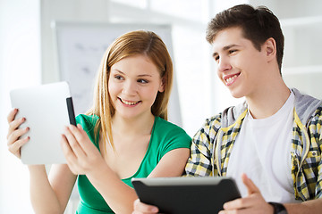 Image showing smiling students with tablet pc at school