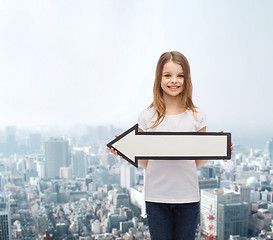 Image showing smiling girl with blank arrow pointing left