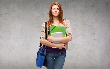 Image showing smiling student with bag, folders and tablet pc