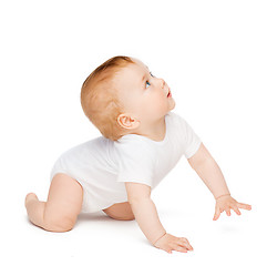 Image showing crawling curious baby looking up