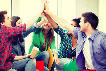 Image showing students giving high five at school
