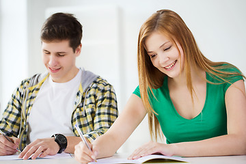 Image showing smiling students with textbooks at school