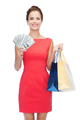 Image showing smiling elegant woman in dress with shopping bags