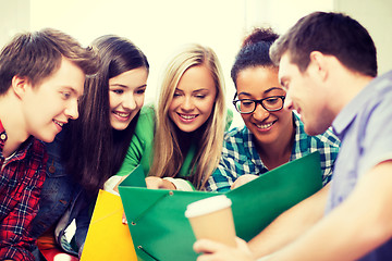 Image showing students looking at notebook at school