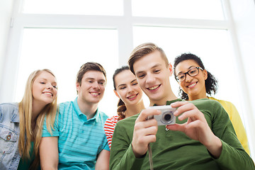 Image showing smiling students with digital camera at school