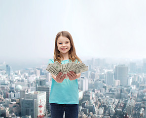 Image showing smiling little girl giving dollar cash money