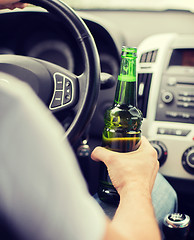 Image showing man drinking alcohol while driving the car