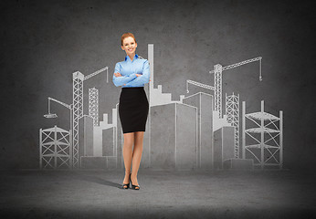 Image showing young smiling businesswoman with crossed arms