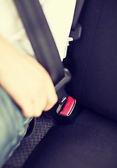 Image showing man fastening seat belt in car