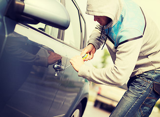 Image showing thief breaking the car lock