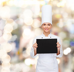 Image showing smiling female chef with black blank paper