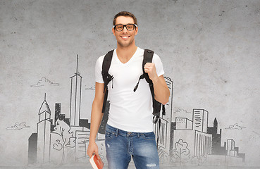 Image showing smiling student with backpack and book