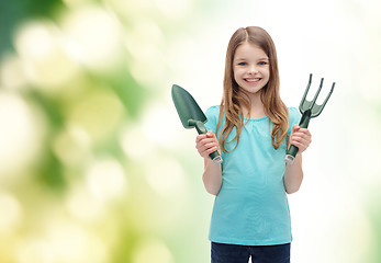 Image showing smiling little girl with rake and scoop