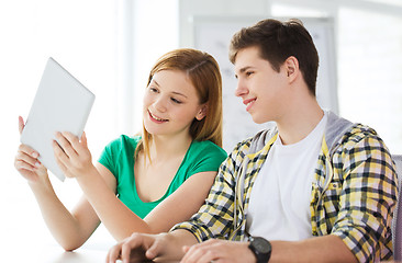 Image showing smiling students with tablet pc at school