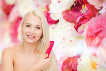 Image showing smiling woman with hair brush