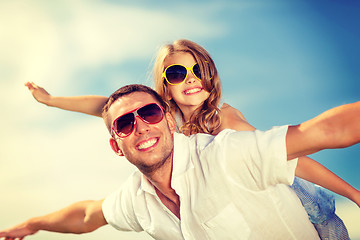 Image showing happy father and child in sunglasses over blue sky