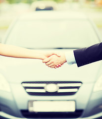 Image showing customer and salesman shaking hands