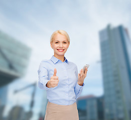 Image showing young smiling businesswoman with smartphone