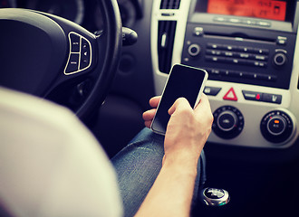 Image showing man using phone while driving the car