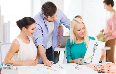 Image showing smiling fashion designers working in office