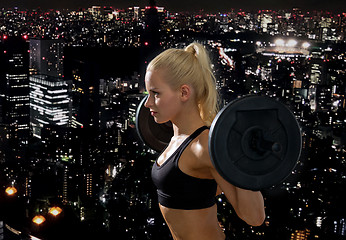 Image showing sporty woman exercising with barbell