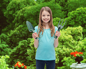 Image showing smiling little girl with rake and scoop