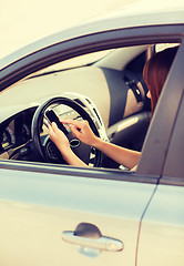 Image showing woman using phone while driving the car