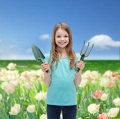 Image showing smiling little girl with rake and scoop