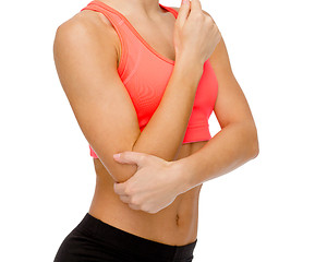 Image showing sporty woman with pain in elbow