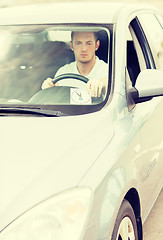 Image showing man placing parking clock on car dashboard