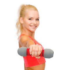 Image showing smiling beautiful sporty woman with dumbbell