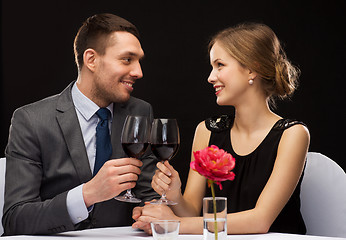 Image showing young couple with glasses of wine at restaurant