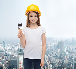 Image showing smiling little girl in helmet with paint roller