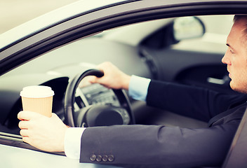 Image showing man drinking coffee while driving the car